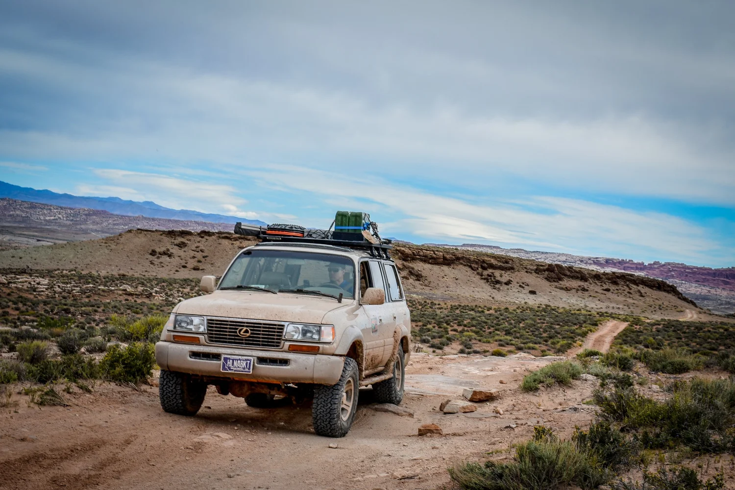Silver Lexus LX450 with a rooftop tent on a desert trail on the 3D Trail at Cruise Moab