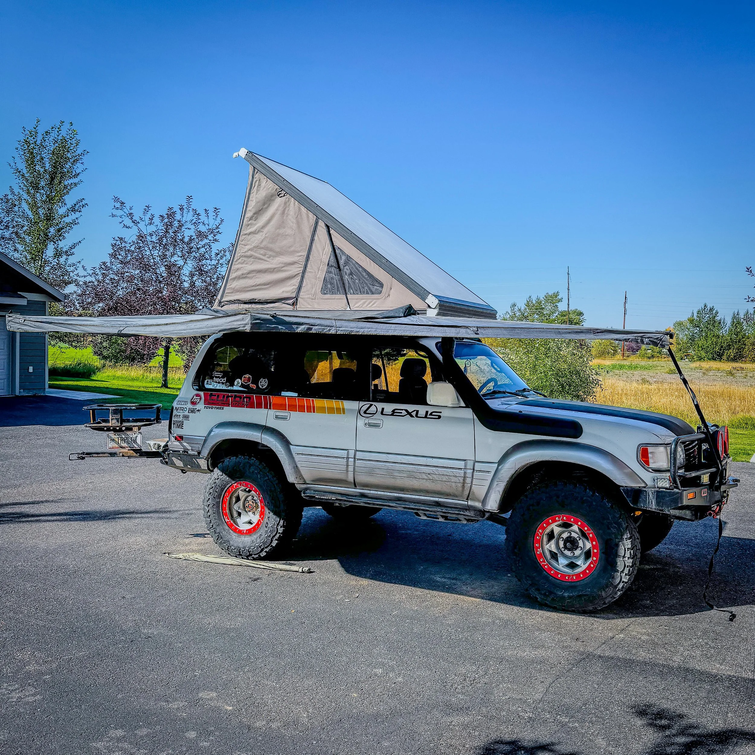 Lexus LX450 camp setup with rooftop tent and 180 awning