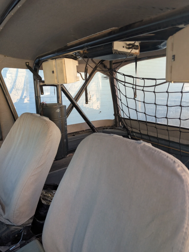 Custom roll cage, speakers and seat covers inside the 1974 Toyota FJ40