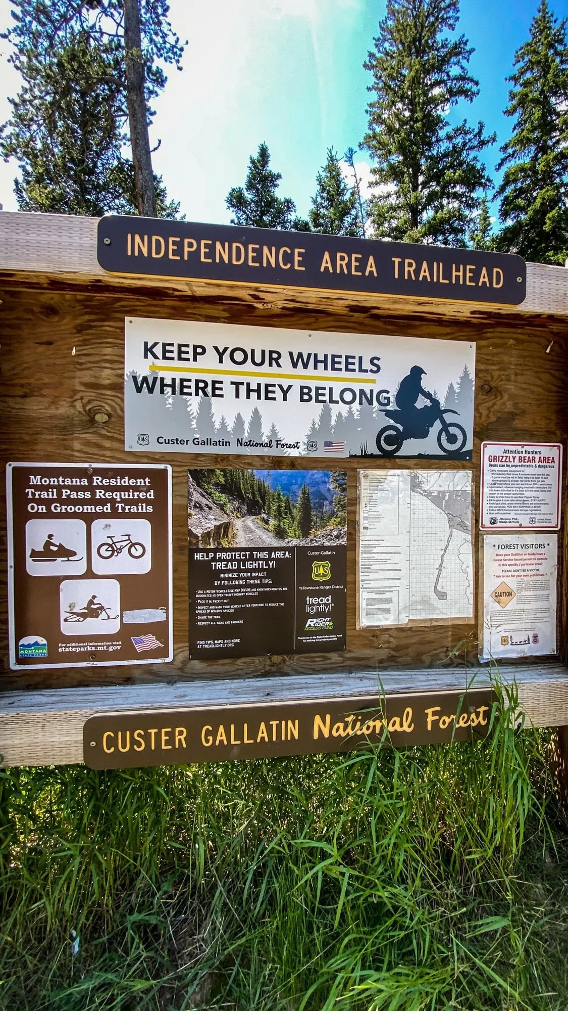 Wooden Independence Area Trailhead kiosk reading Keep Your Wheels Where They Belong, Custer Gallatin National Forest on the Independence road above the Boulder River, Montana