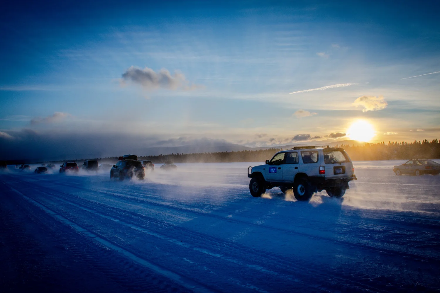 Toyota 4Runner driving across a frozen runway at sunset at the Frost and Furious ice races in West Yellowstone