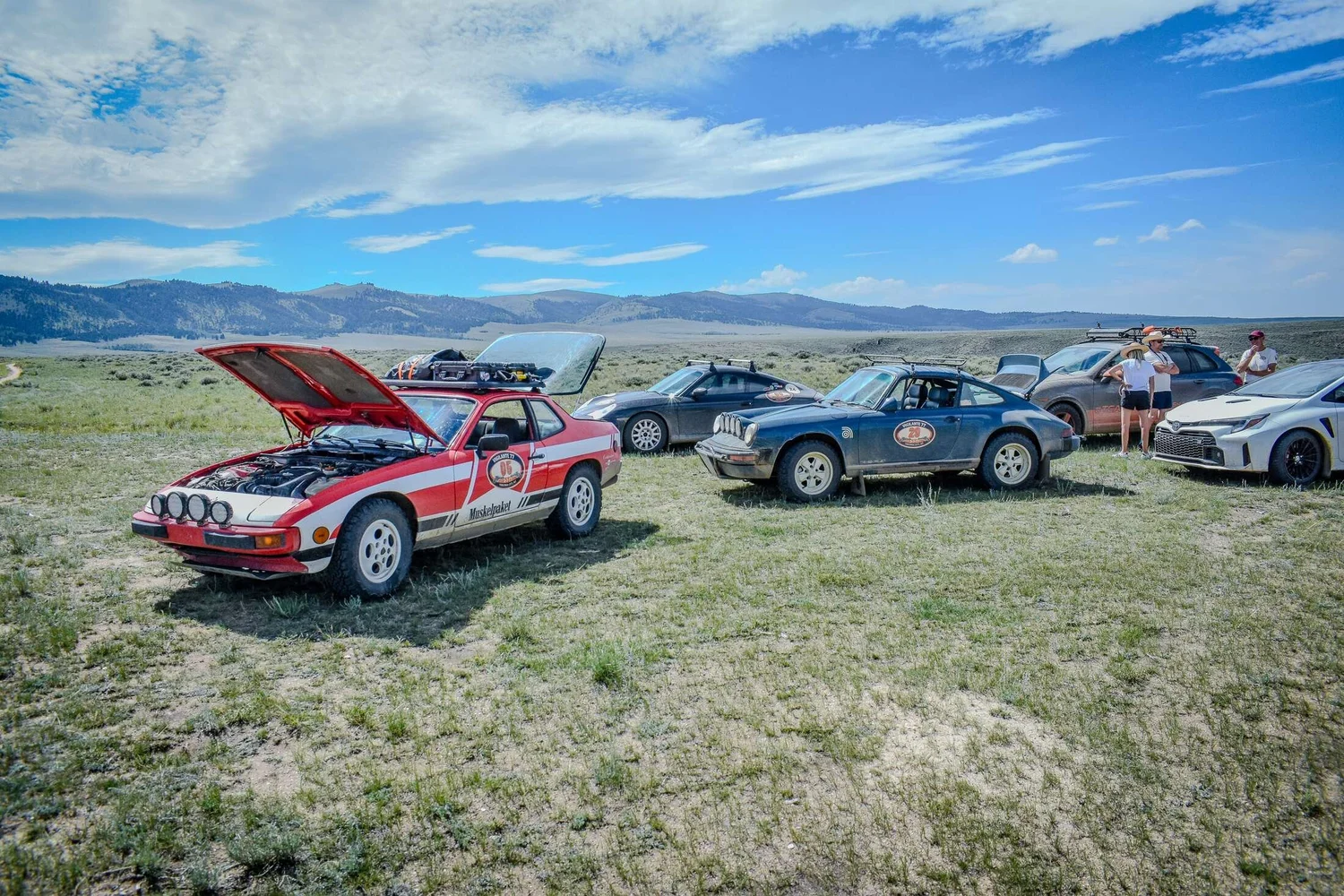 Lineup of dusty rally cars during the Vigilante 77 Sunday Dirt Crew