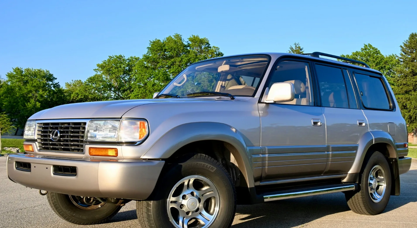 Champagne Pearl 1997 Lexus LX450 with factory triple lockers parked on pavement