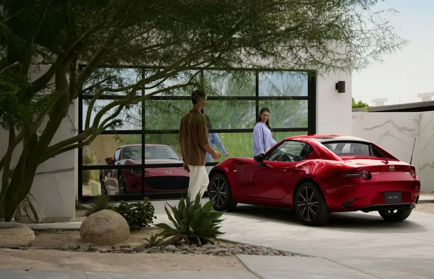 Red 2026 Mazda MX-5 Miata RF retractable hardtop parked in a driveway