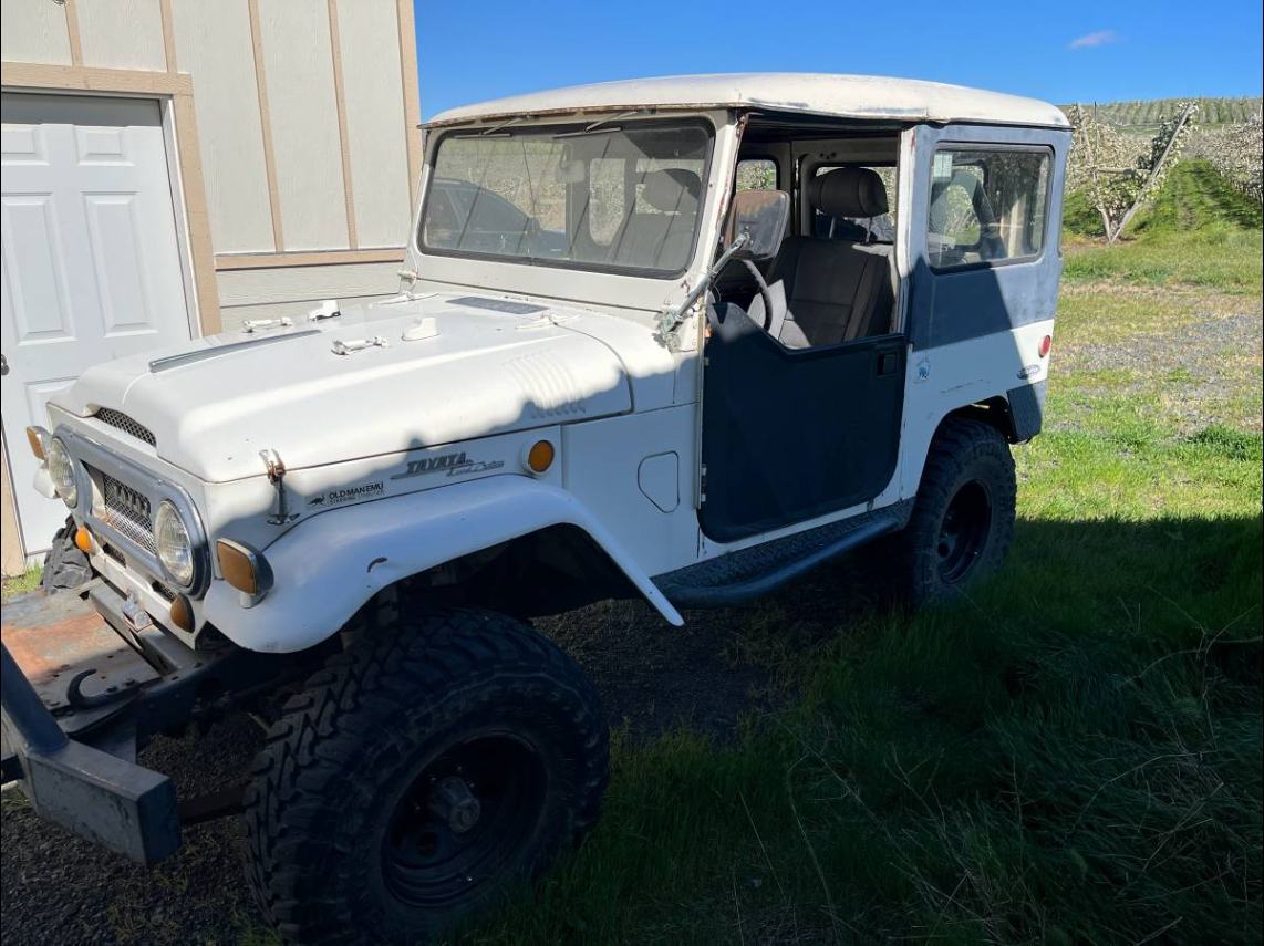 White 1969 Toyota FJ40 with half doors parked by an orchard near Yakima, Washington