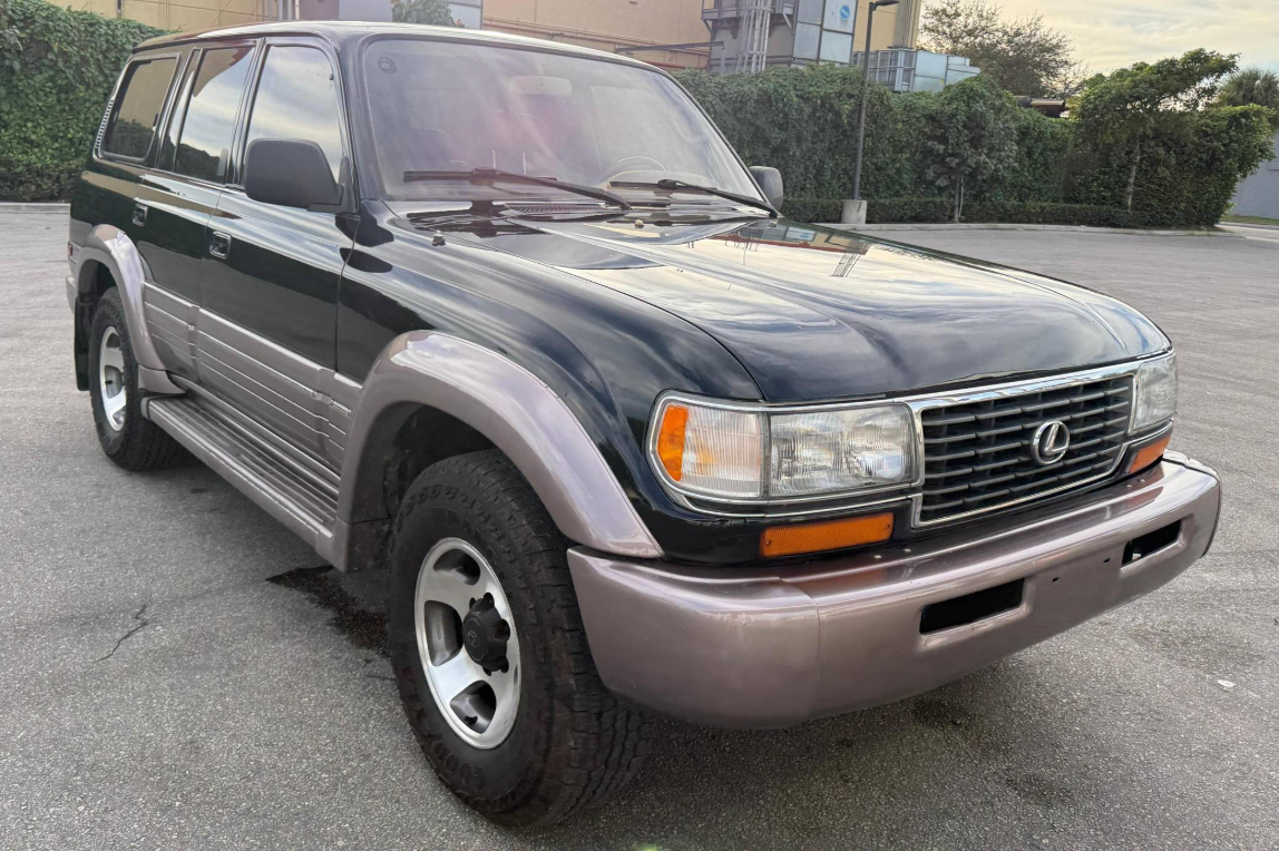 Black 1997 Lexus LX450 with gray lower cladding in a Florida parking lot