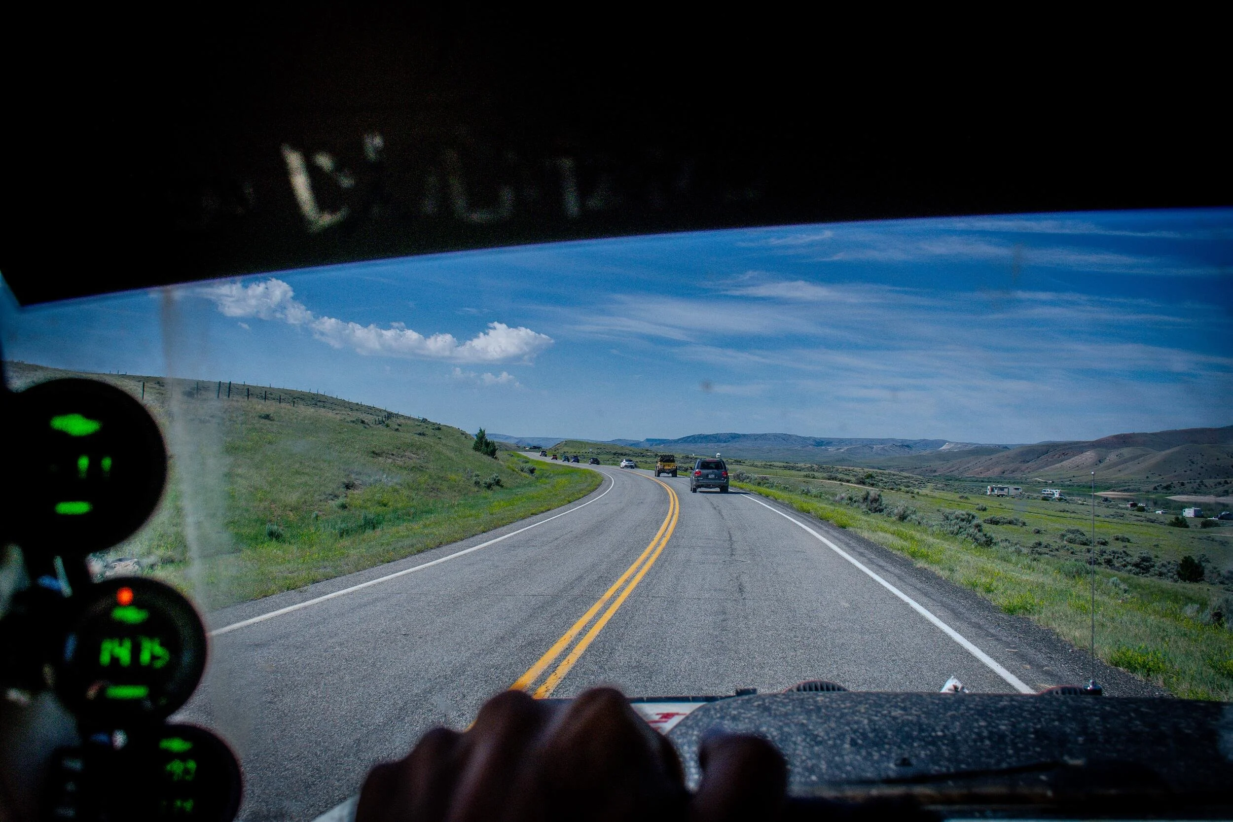 View through a rally vehicle windshield as the Sunday Dirt Crew leaves the pavement in Montana