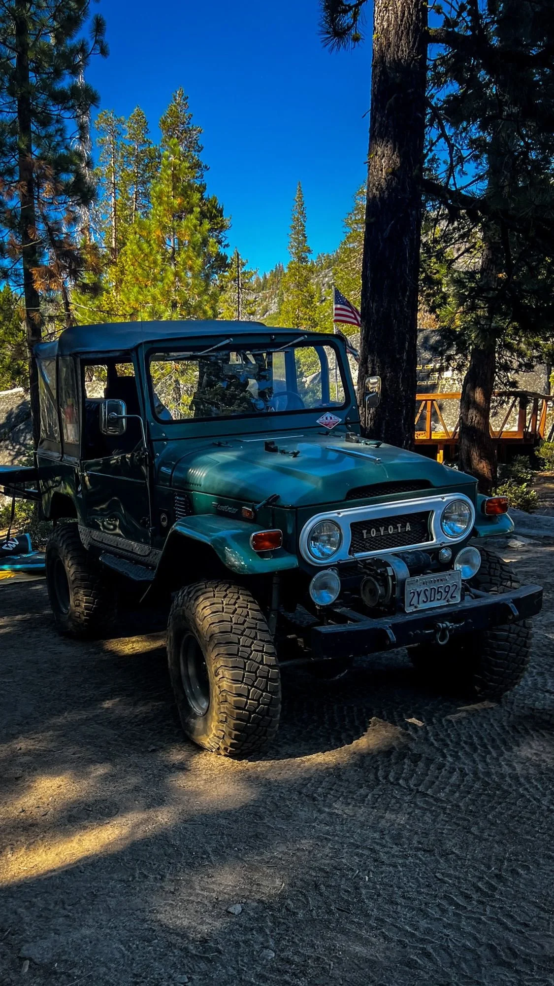 Green Toyota FJ40 parked in a shady pine camp on the Rubicon Trail in California during Rubithon 2022