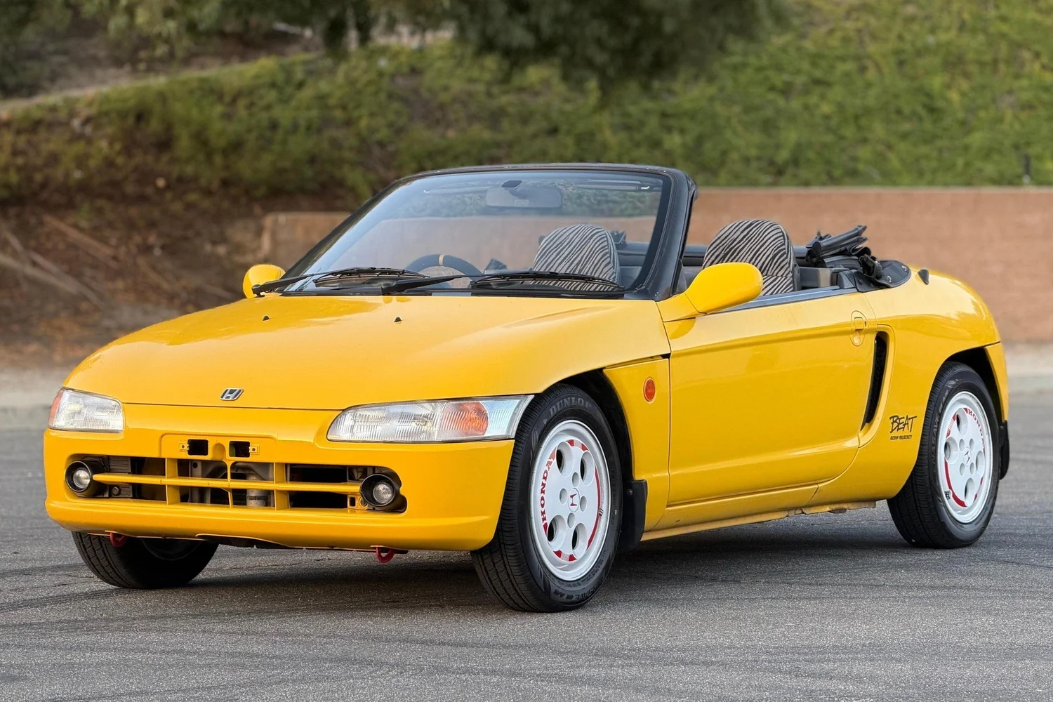 Carnival Yellow 1991 Honda Beat with the top down and zebra seats