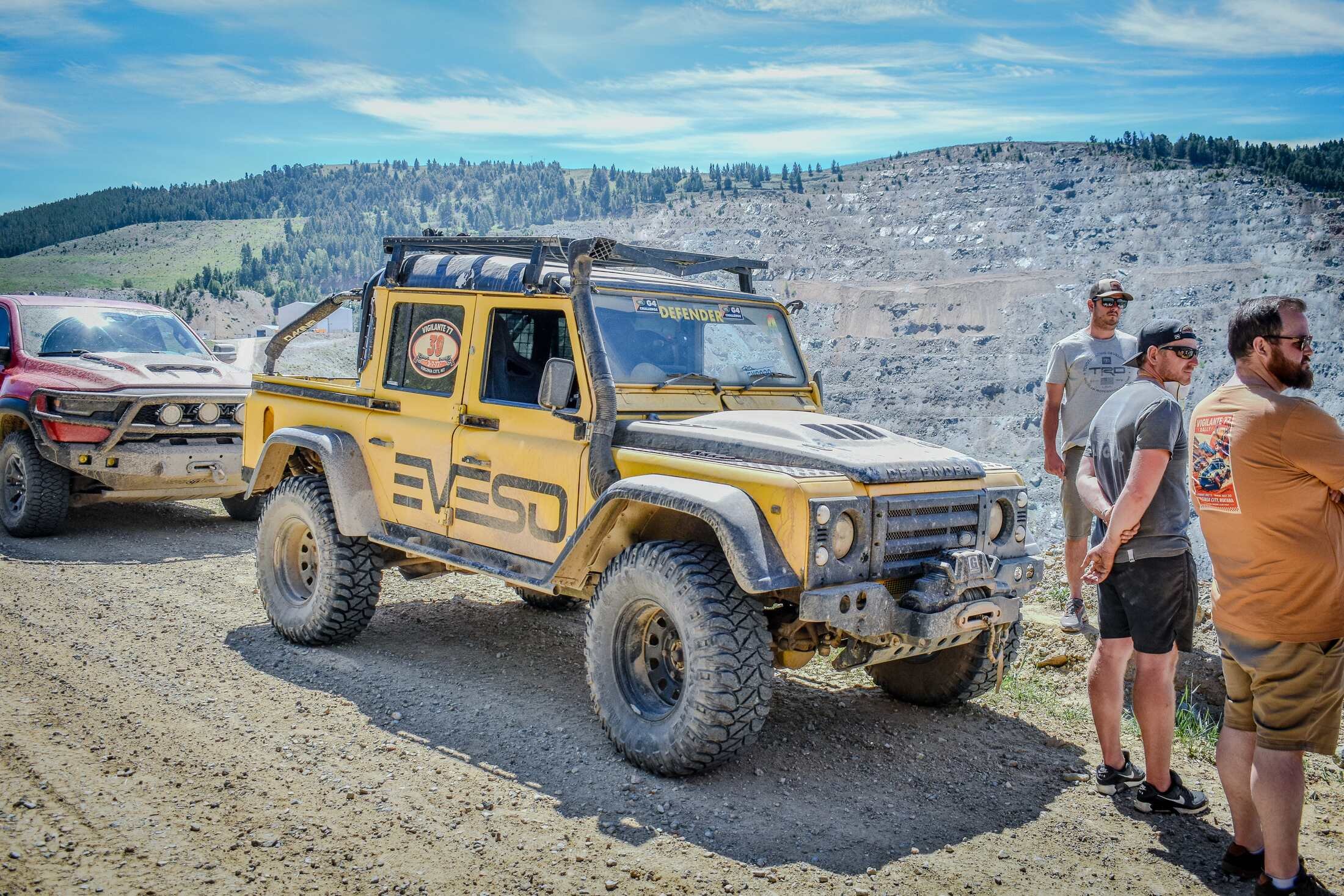 Yellow Land Rover Defender parked with the rally crew in Montana