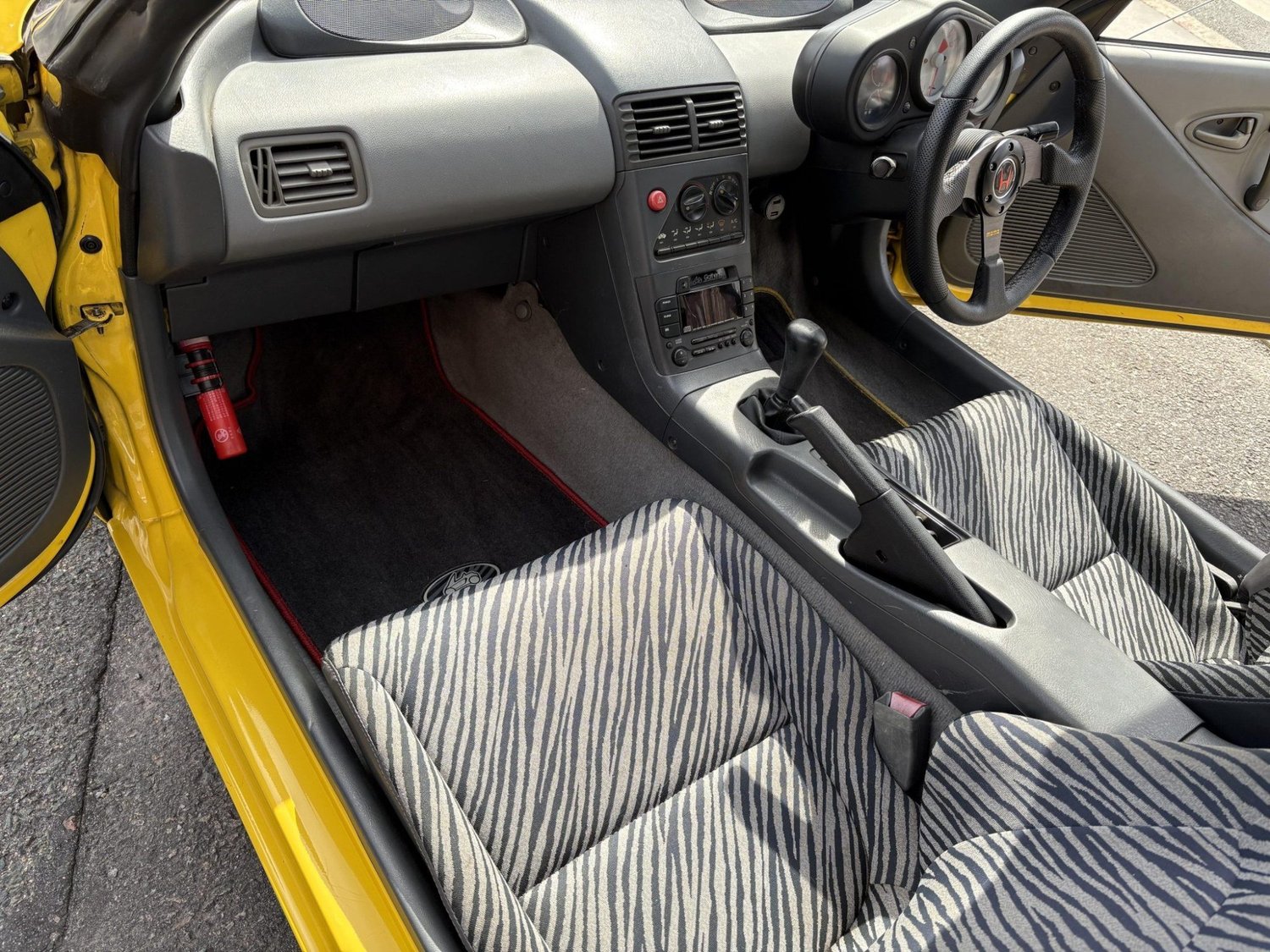 Zebra-print cloth seats and MOMO steering wheel in the 1992 Honda Beat