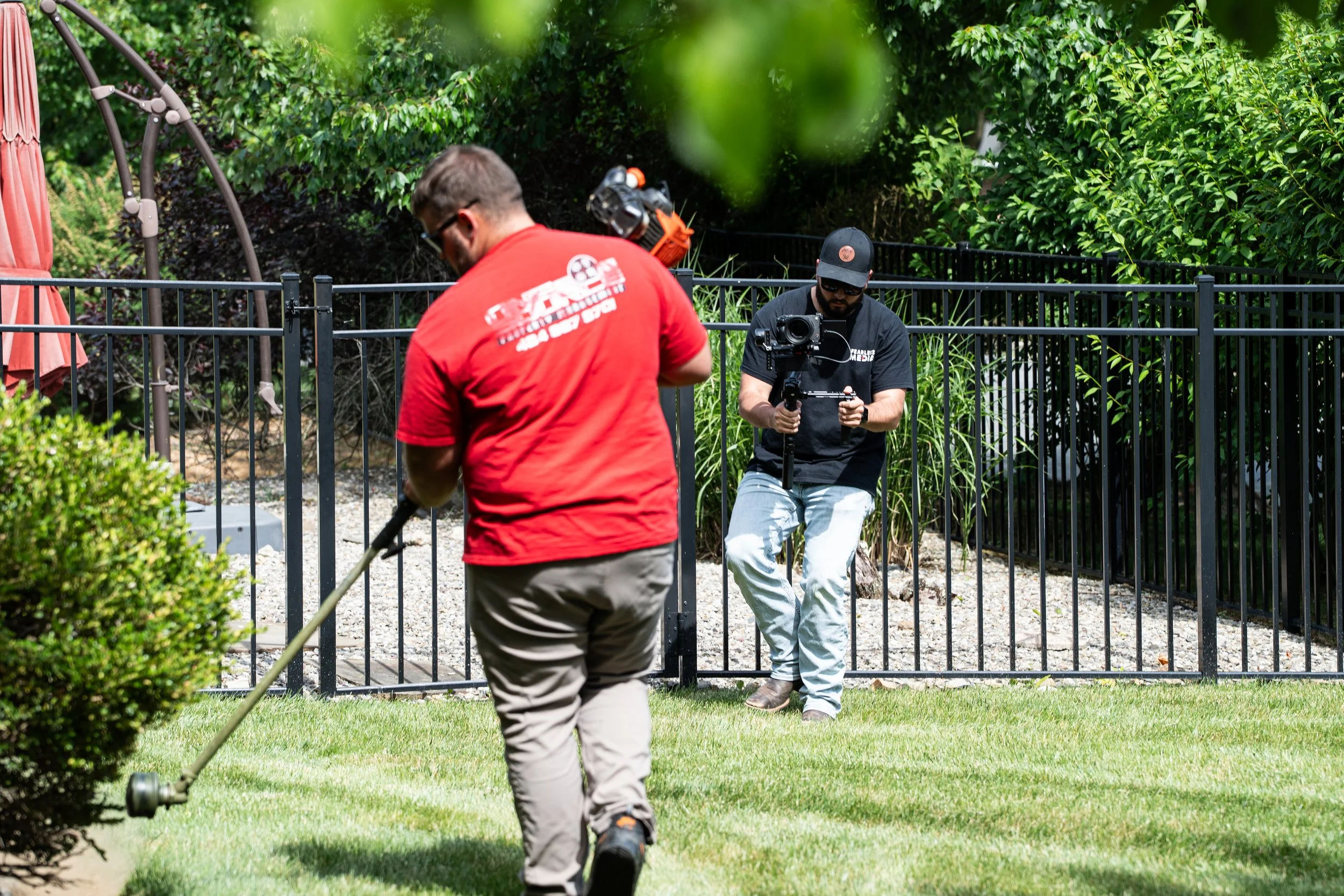 Fearless Media videographer filming a landscaper at work