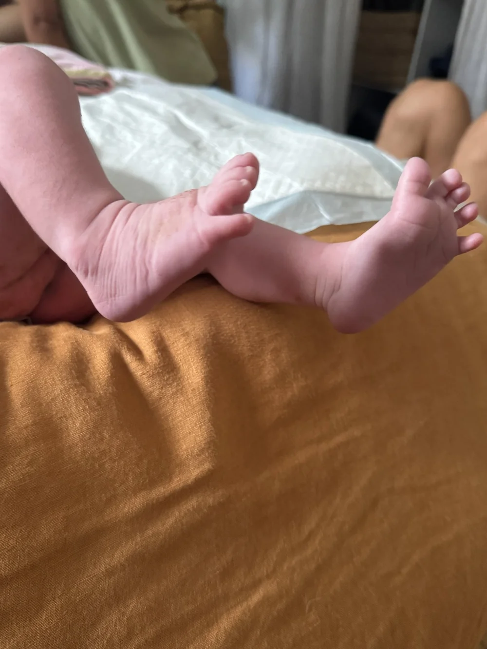 Newborn baby feet during a postpartum doula visit at home