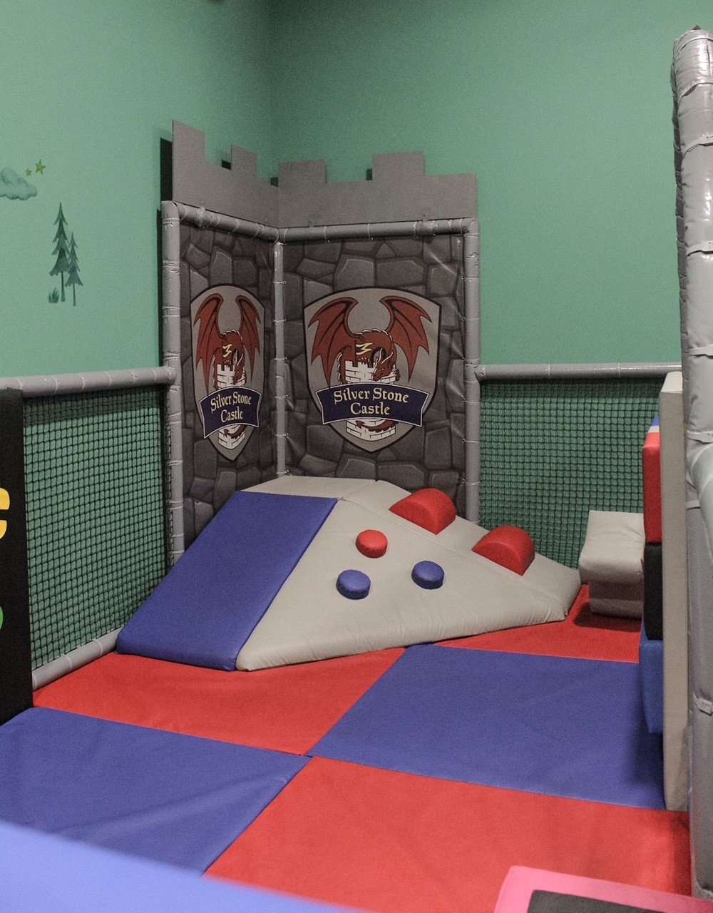 The toddler soft-play corner under the crest
