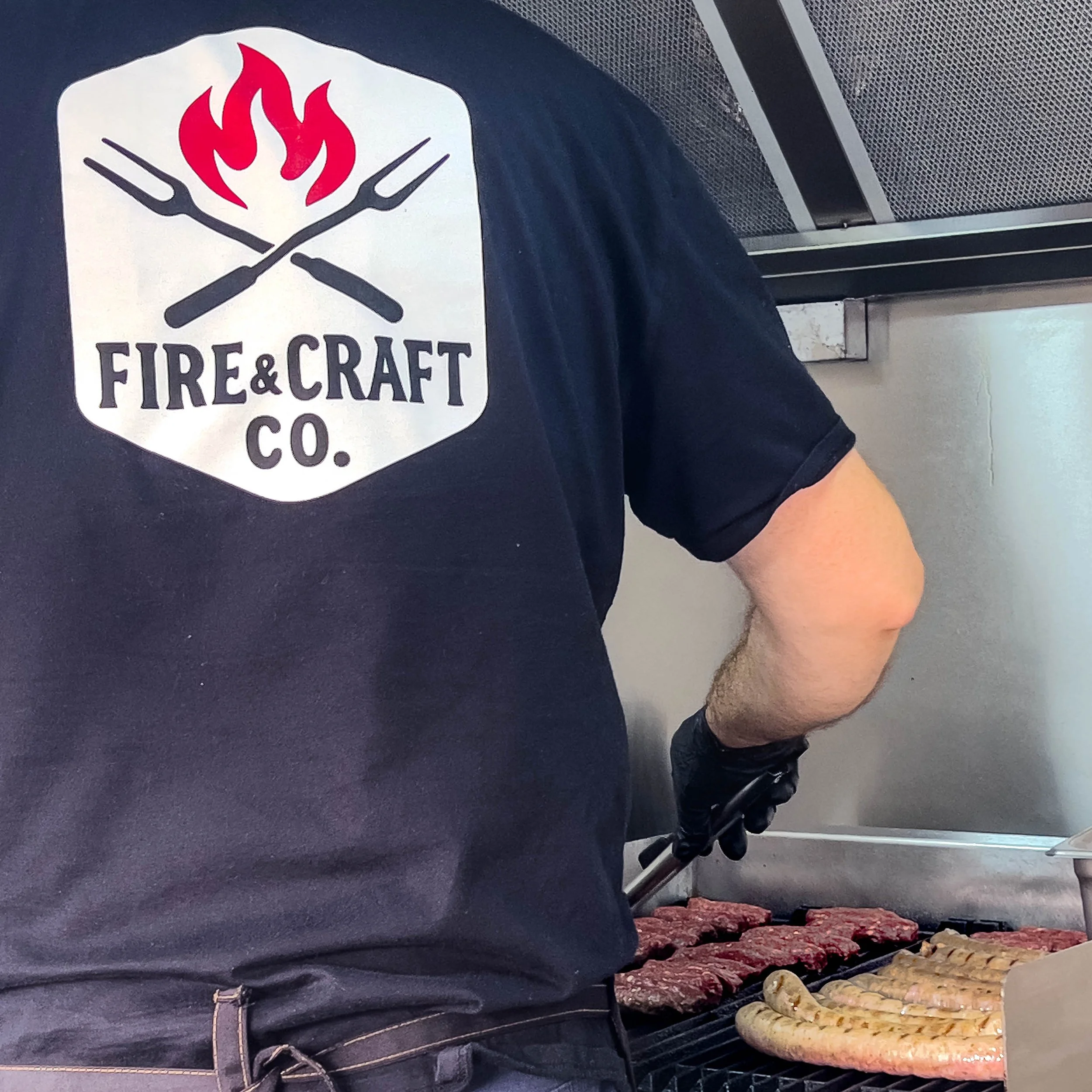 Fire & Craft Co grilling hand-crafted sausages