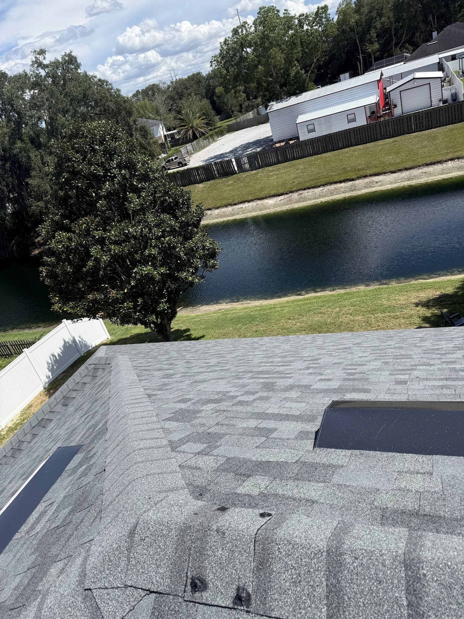 Exhaust vents installed near the ridge of a new shingle roof