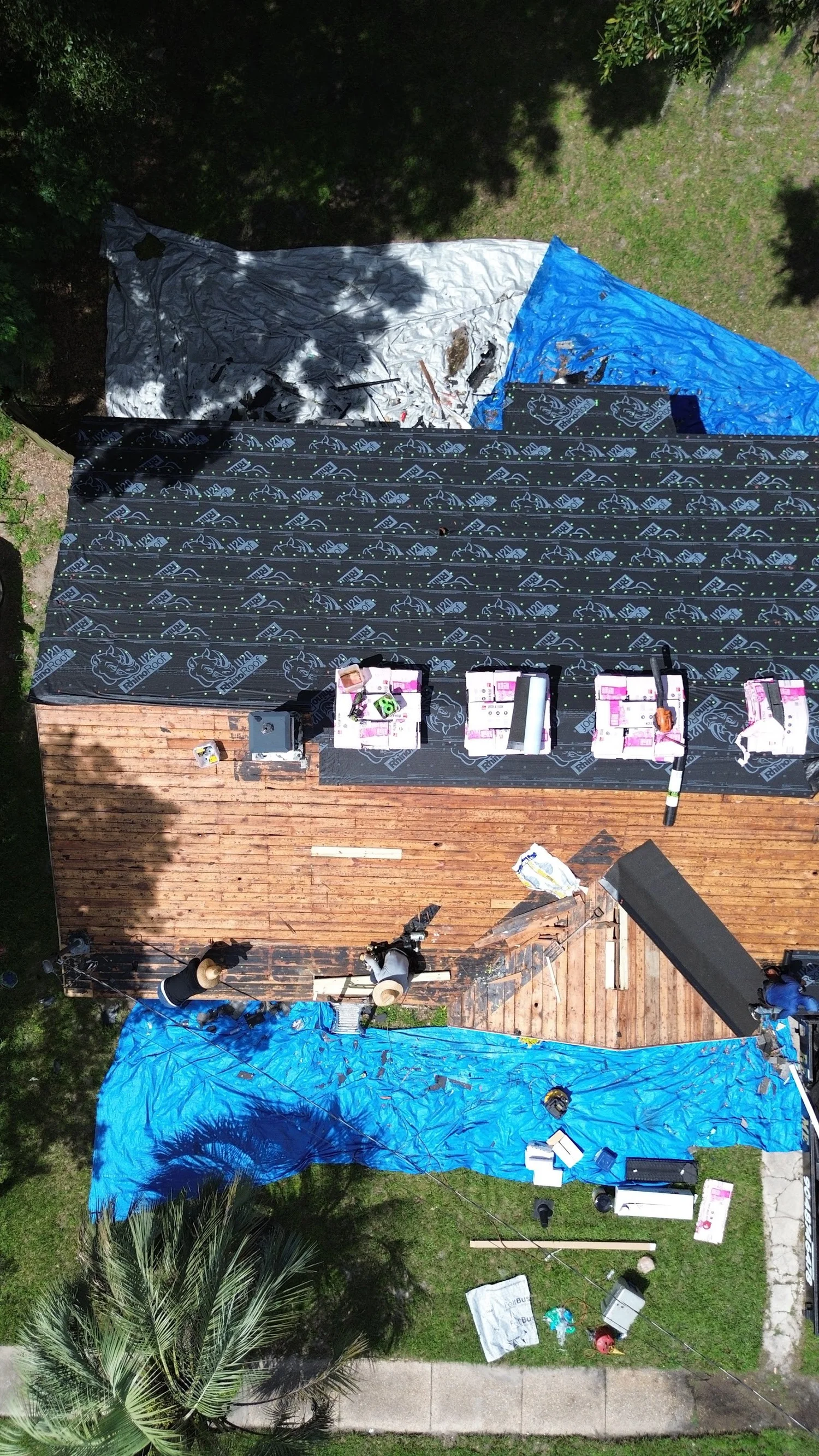 Drone view of a roof replacement in progress with new underlayment