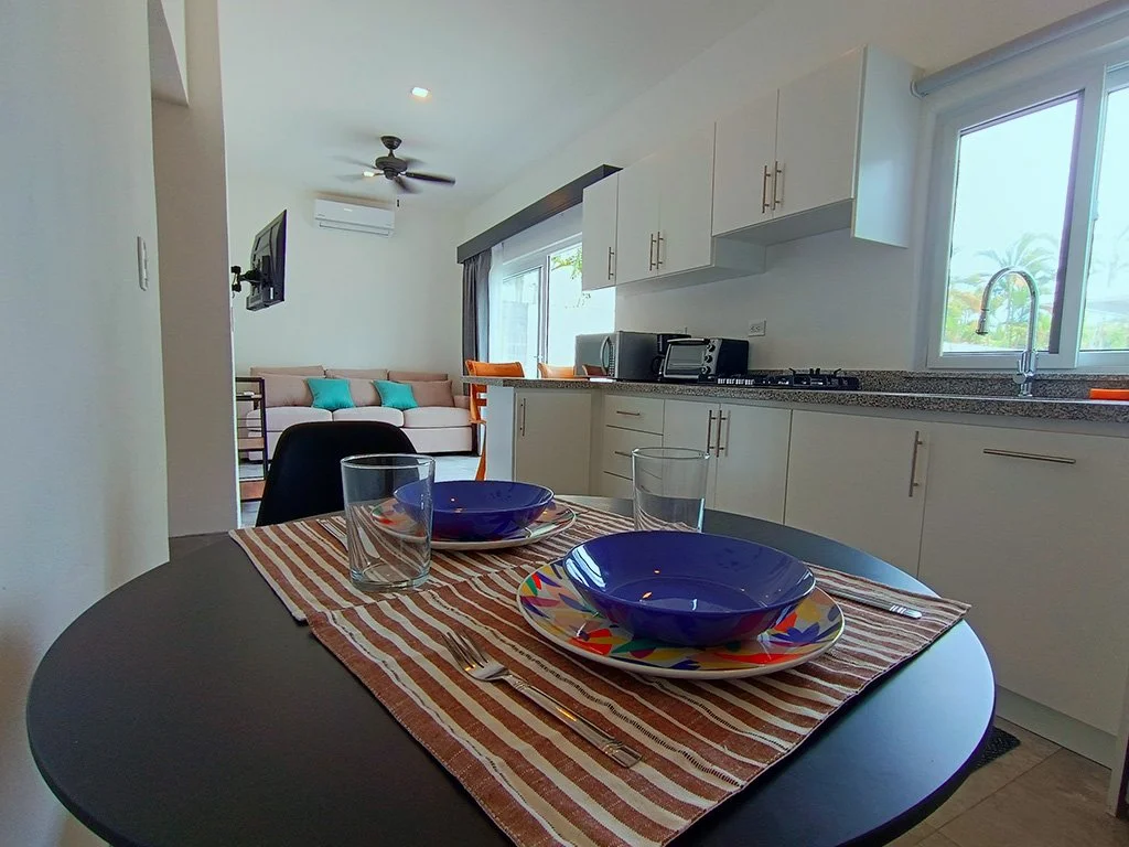 Fully equipped modern kitchen with dining setup at Belford Apartments vacation rental in Jacó Beach Front, Costa Rica.