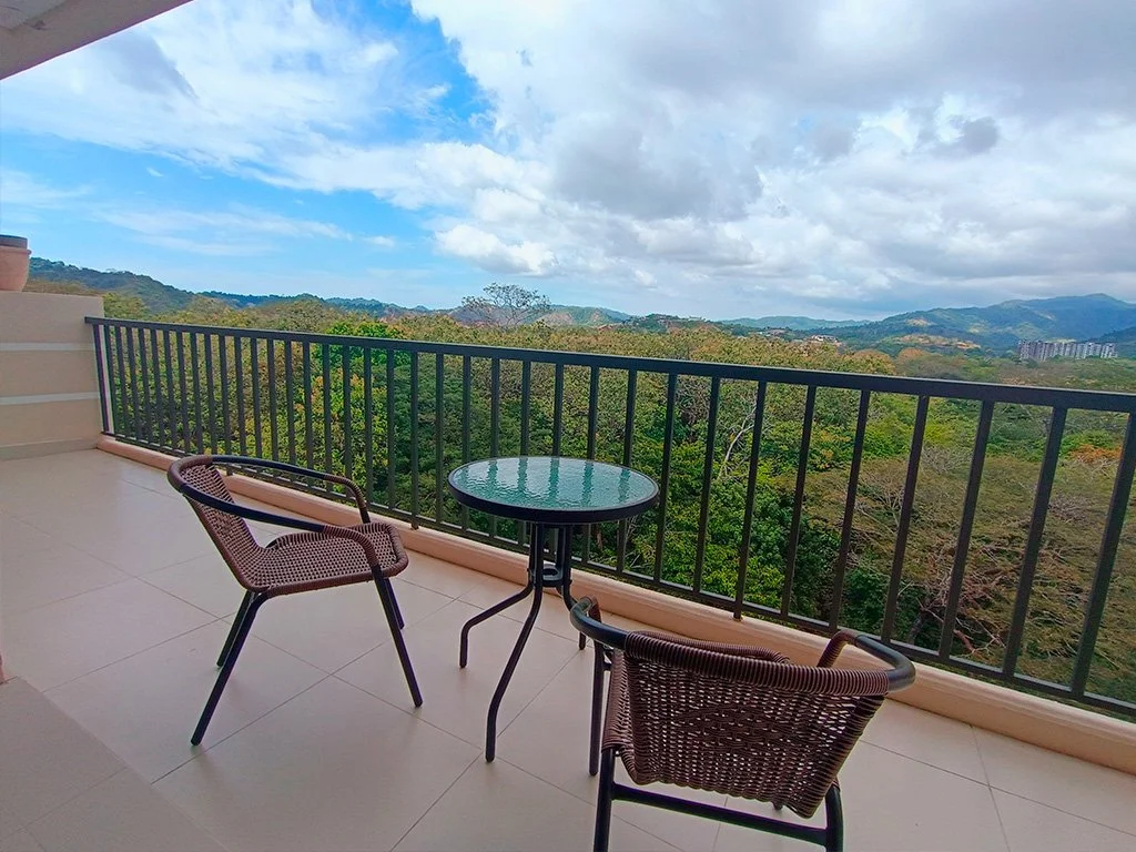 Scenic balcony overlooking lush tropical mountains at Jacó Bay vacation rental in Jacó, Costa Rica.