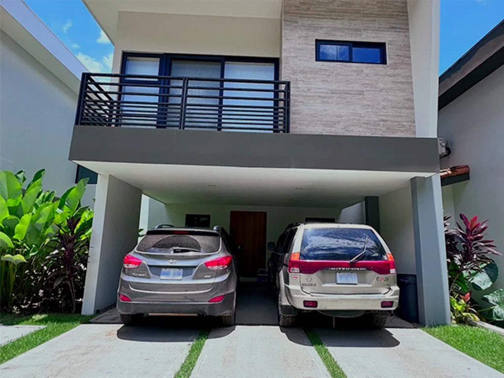 Front view of Casa LaVerde Ópera Salvaje in a gated community in Costa Rica with private covered parking.