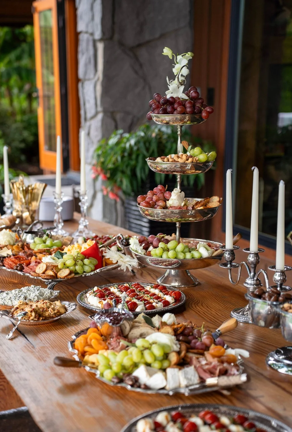 A three-tier silver stand piled with grapes