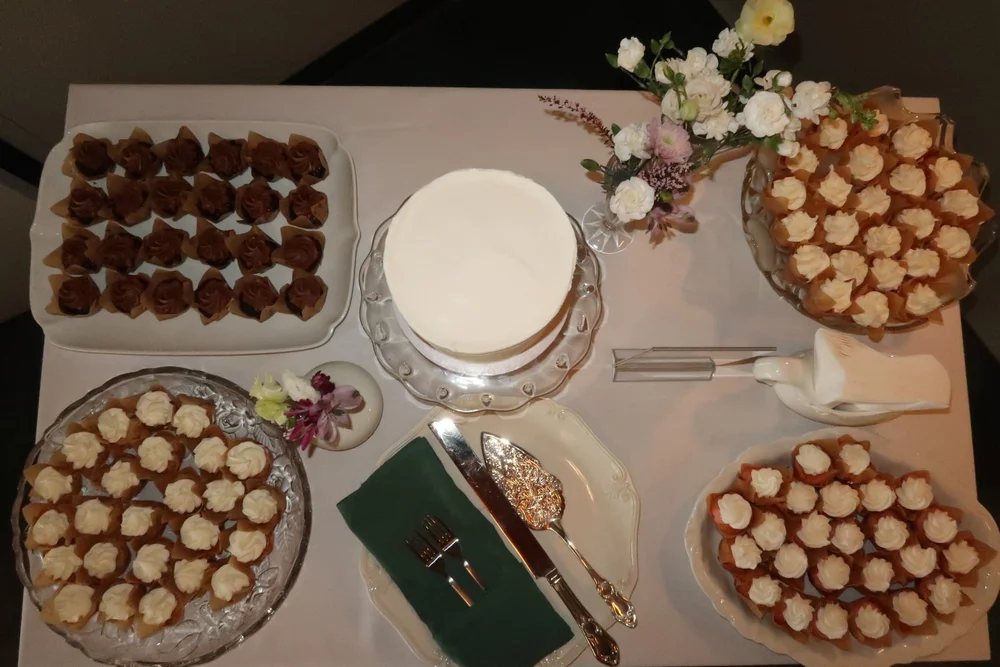 A dessert spread with cake, chocolates and cream puffs