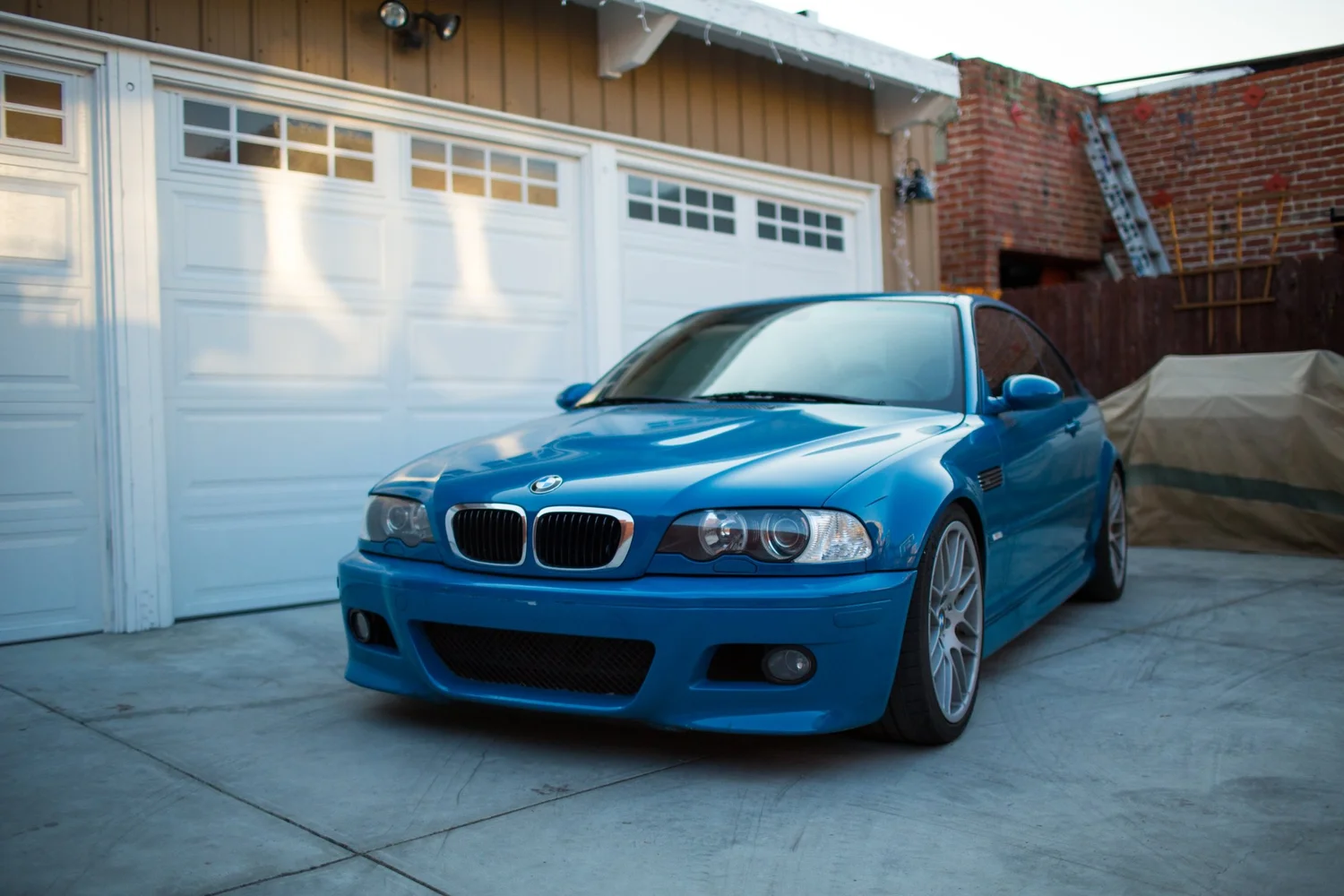 Blue BMW M3 coupe parked in a driveway