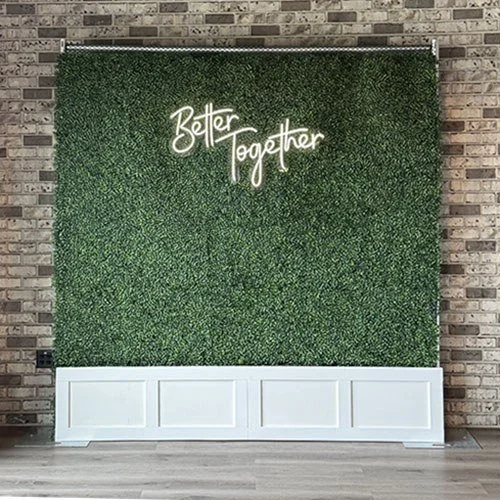 Boxwood Hedge Wall with a Better Together sign.