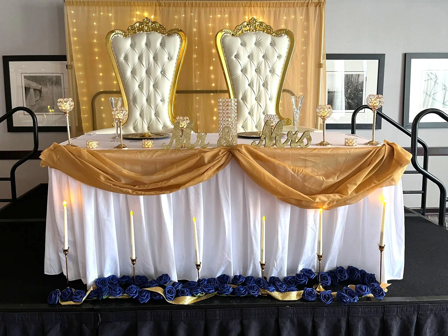Gold and white throne chairs at a wedding.
