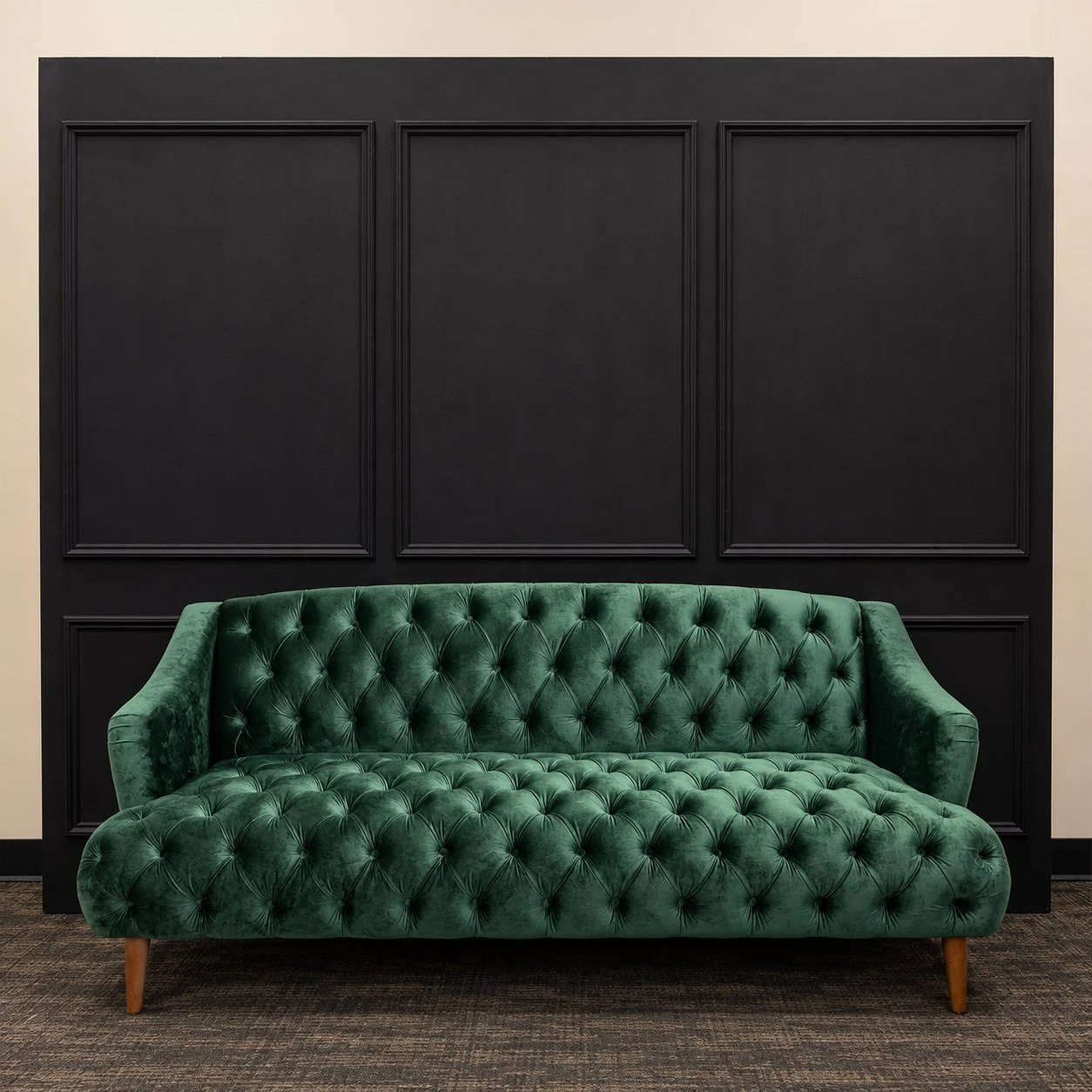 Modern Green Couch in front of a black paneled wall.