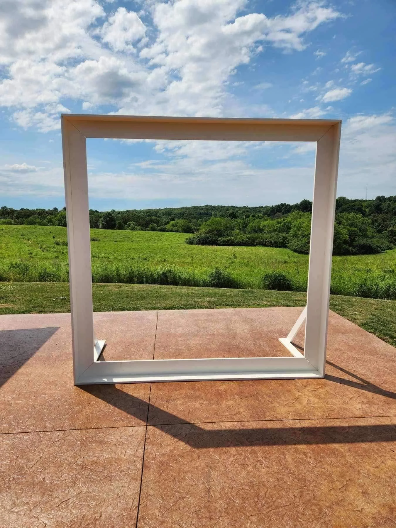 White Wood Frame set outdoors against a countryside view.