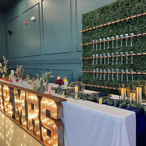 Champagne wall and a Mr and Mrs sign at an event.