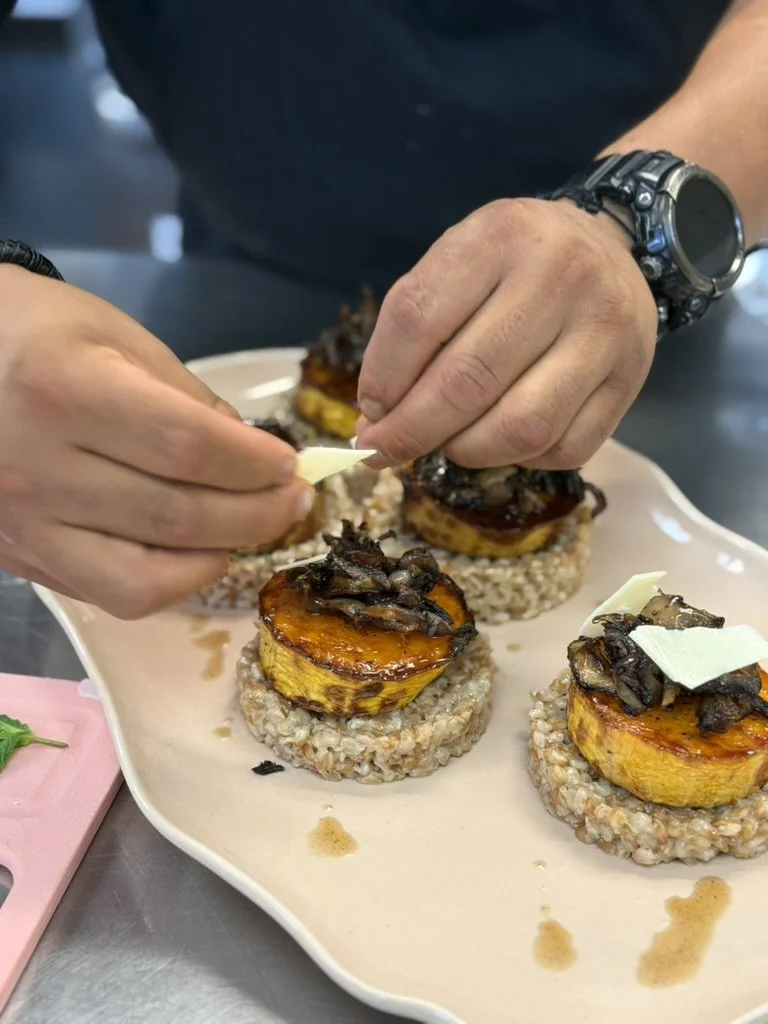 A Lavender Haze chef finishing food by hand