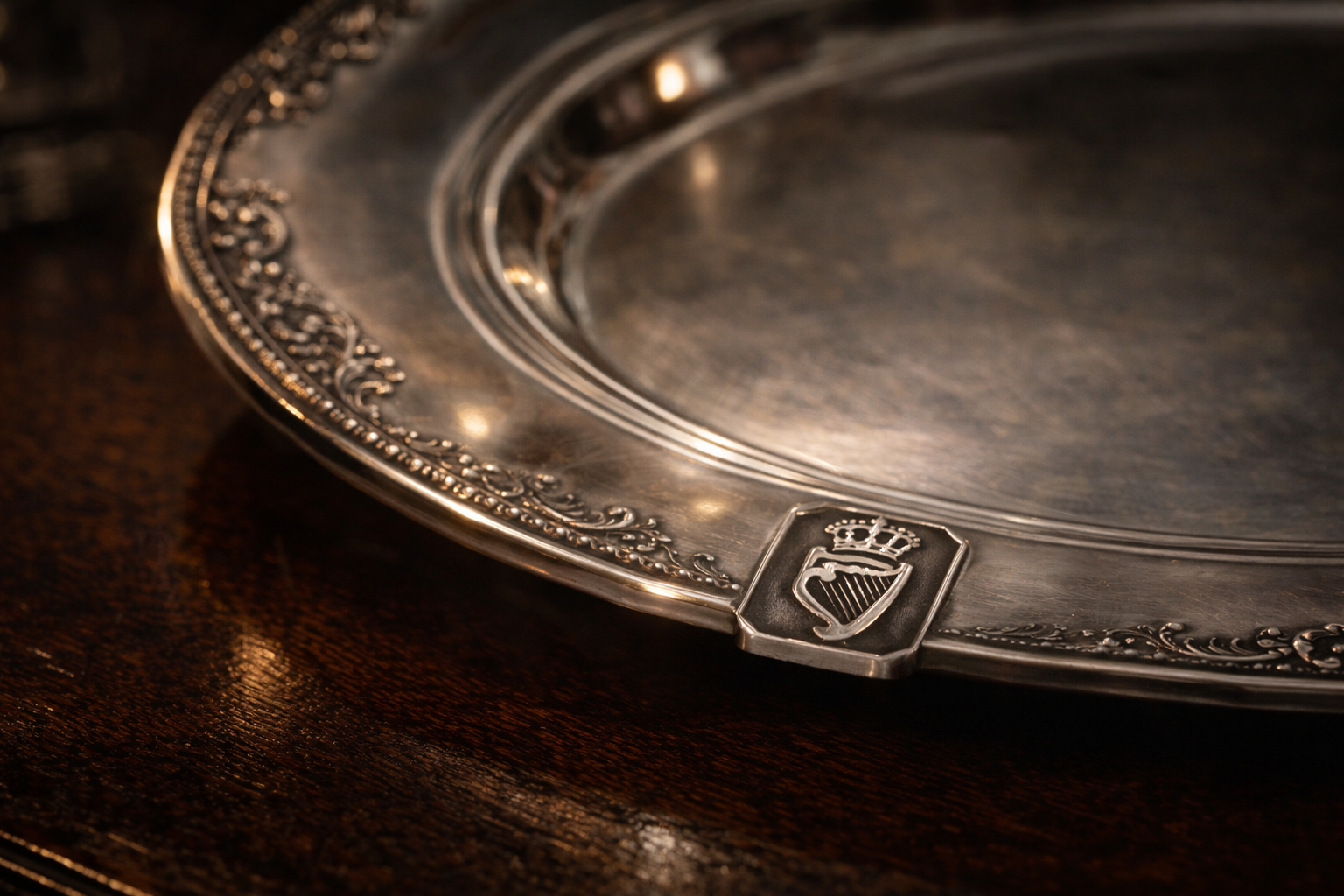 Antique Irish sterling silver plate featuring the Crowned Harp hallmark of Dublin