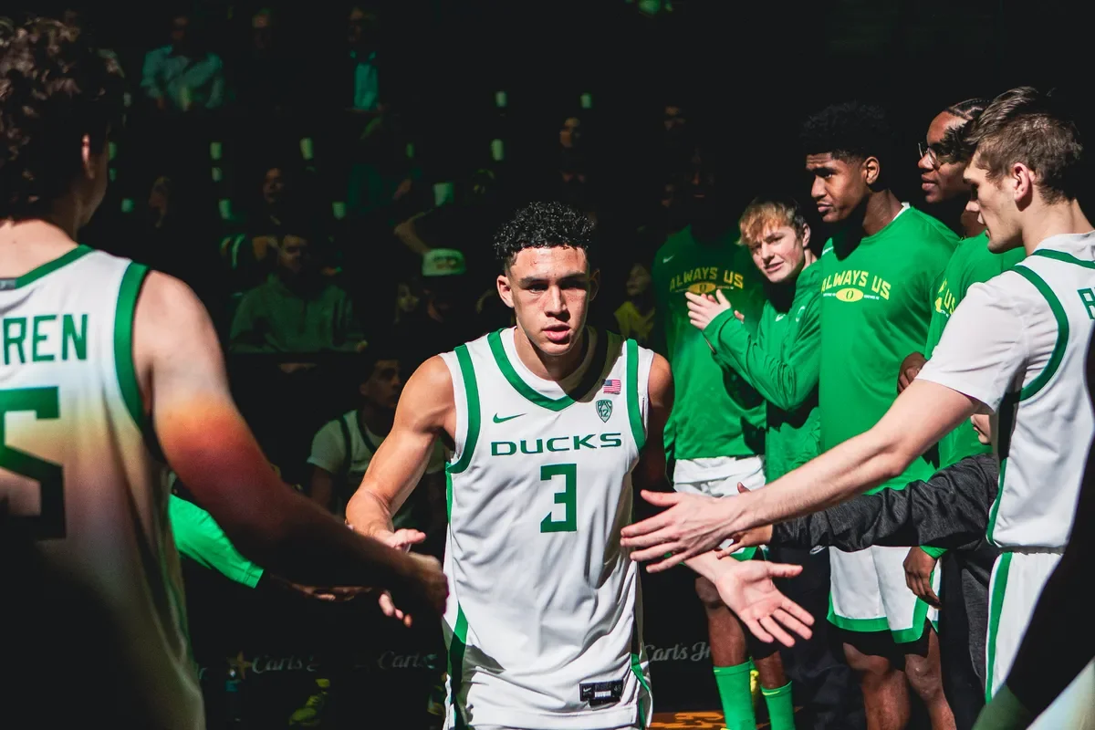 Oregon basketball player greets teammates before a game.