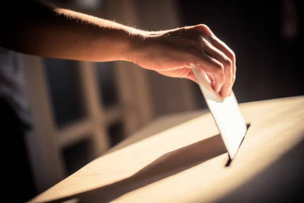 hand casting a vote