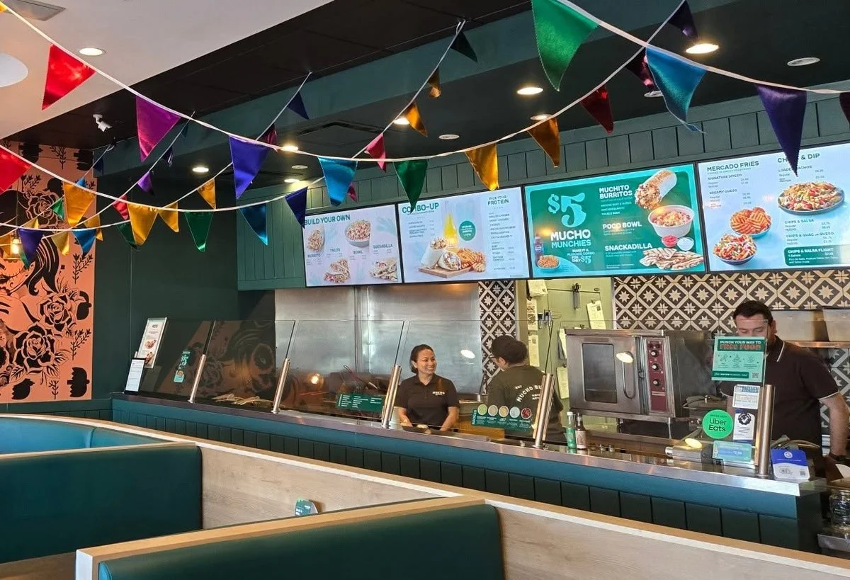 Team serving at the counter of a Mucho Burrito restaurant