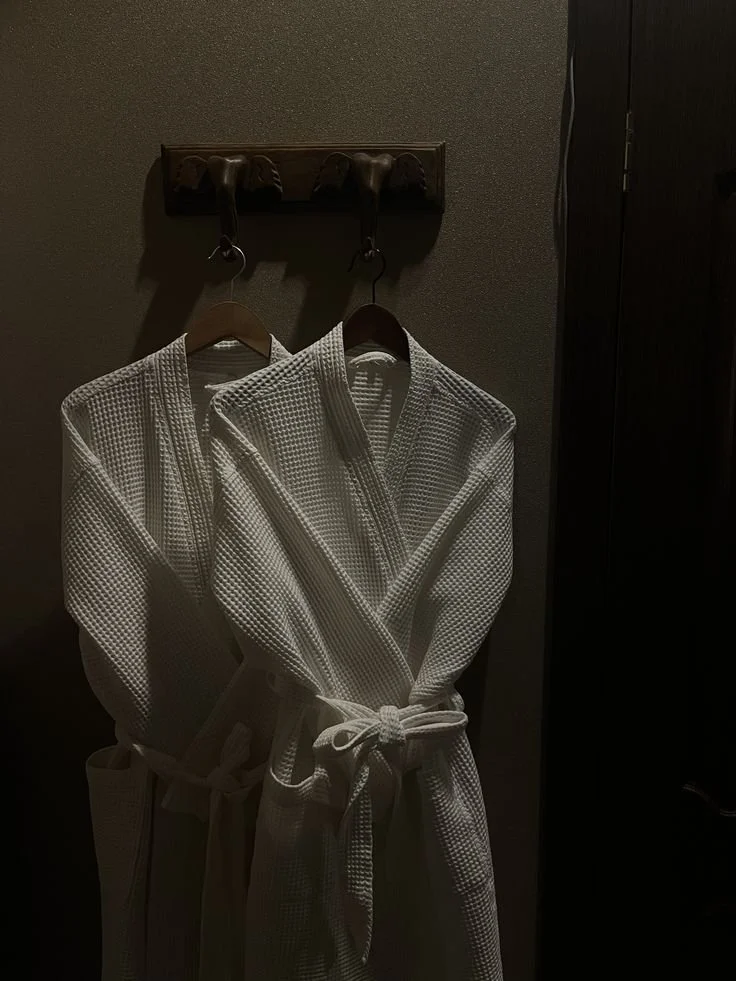A robe hanging by the window