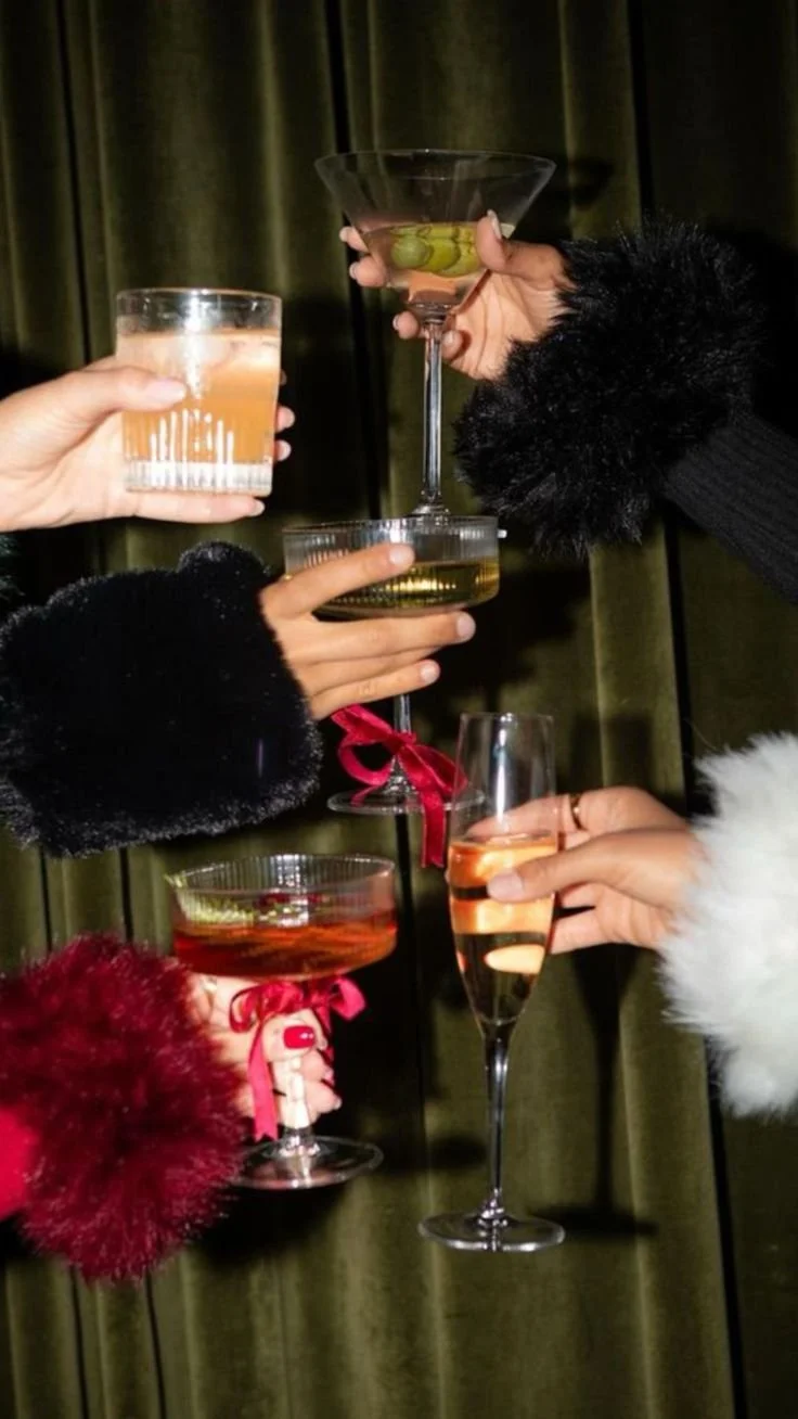 Friends toasting at a booth