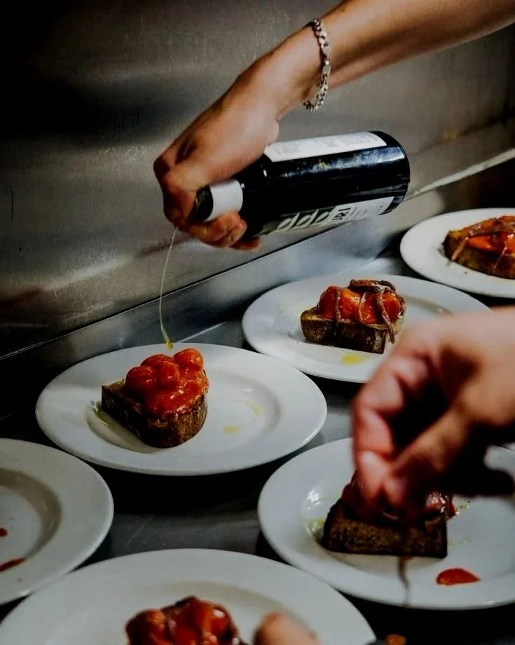 Olive oil poured over a course