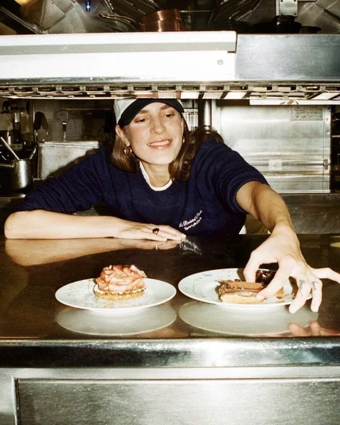 The chef at the pass with dessert