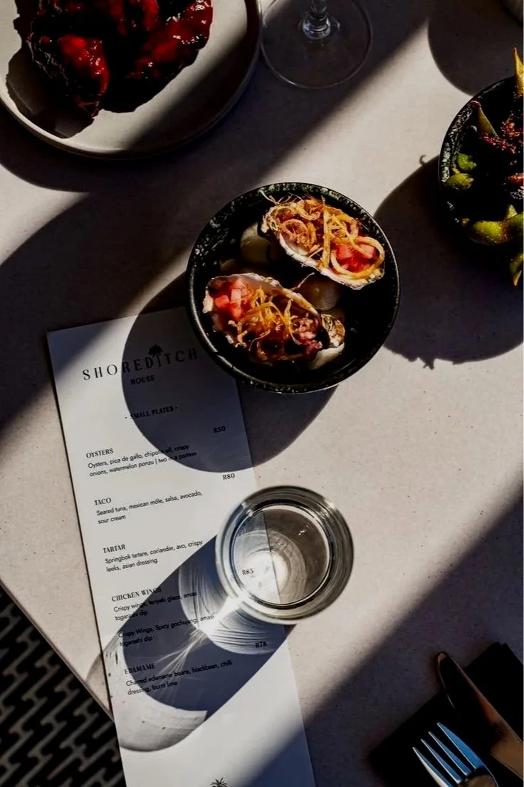 A plated course beside the printed menu
