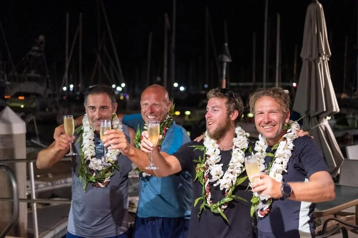 Darren, Simon, Arron, and Josh of the Endurance Limits Pacific Ocean Crossing team celebrating their arrival in Hawaii after completing the adventure.