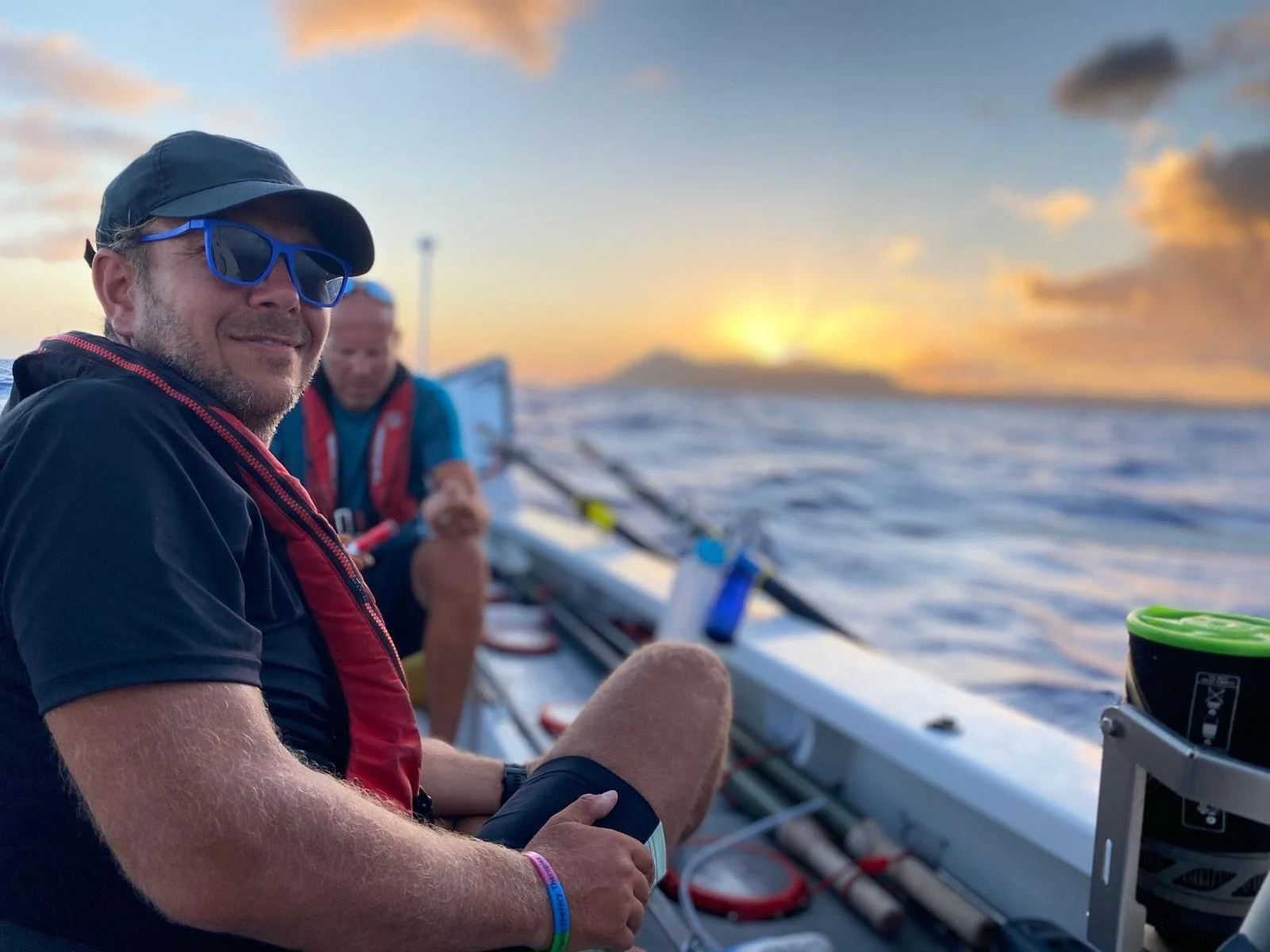 Simon and Darren of the Endurance Limits Pacific Ocean Crossing team rowing together at sunset during the adventure.