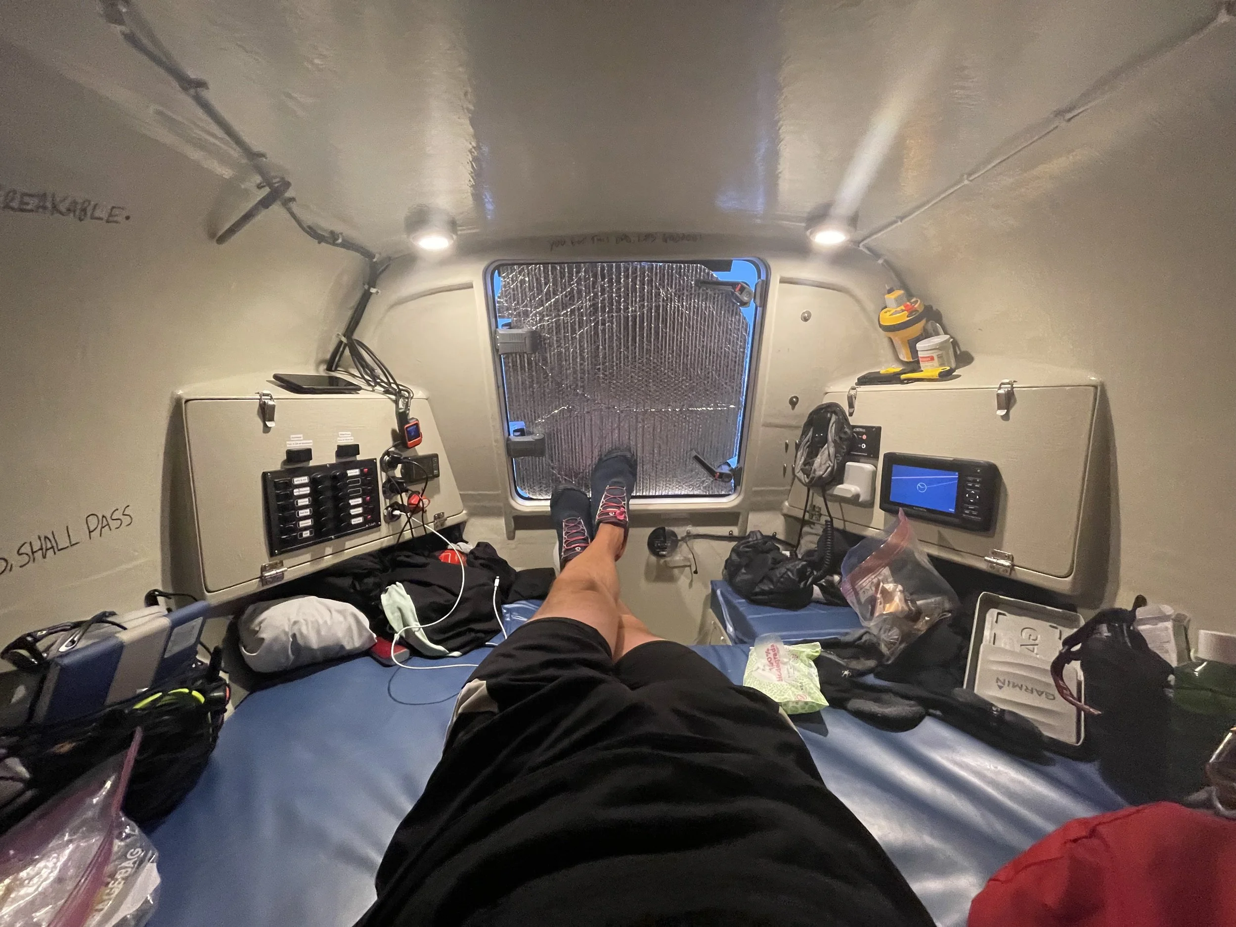 Darren of the Endurance Limits Pacific Ocean Crossing team inside the rowing boat cabin during the expedition.
