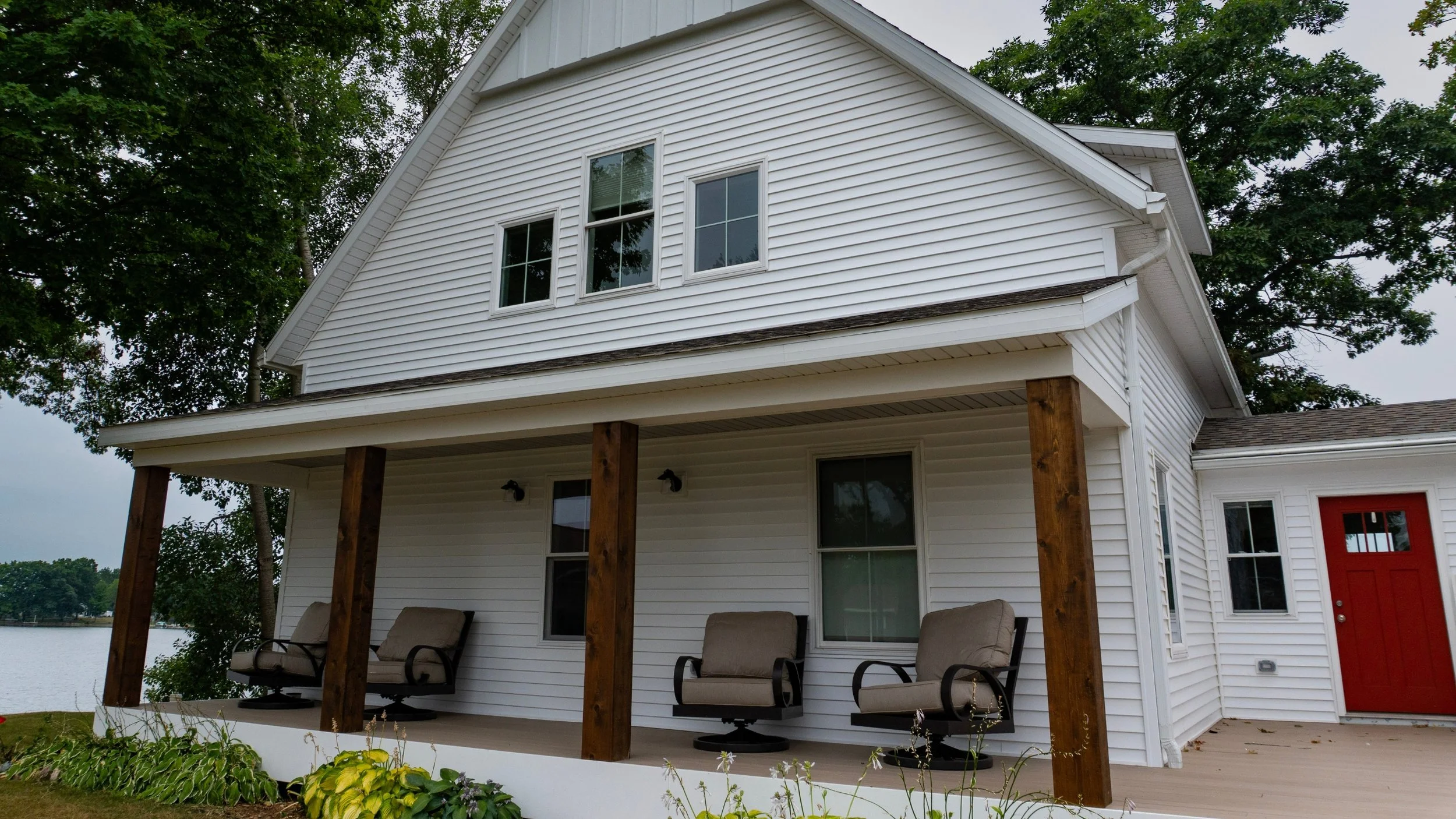 White lakefront residence with a custom exterior and prefinished columns