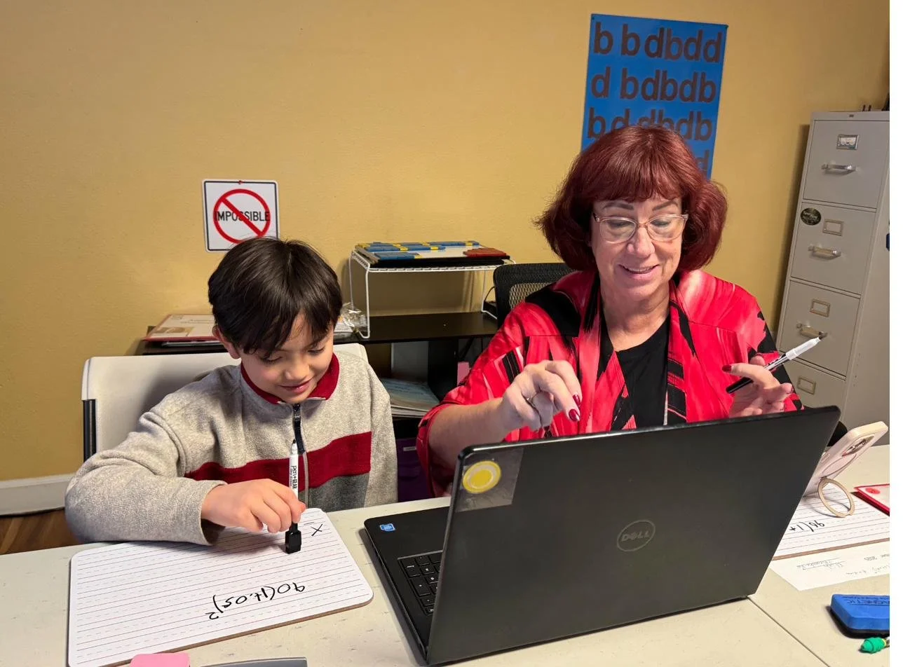 Renee working one-on-one with a student at The Learning House