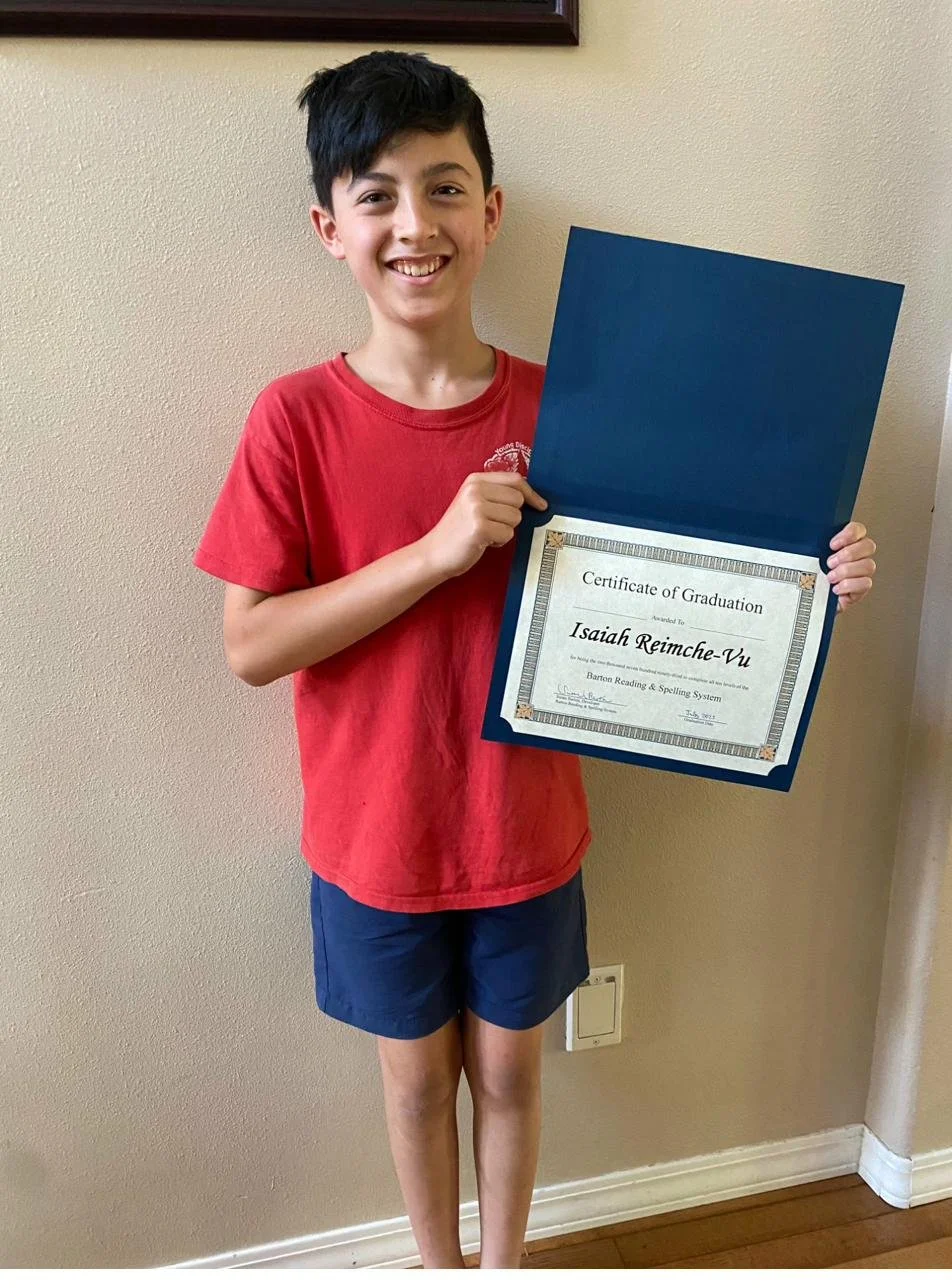 Proud student with Barton graduation certificate