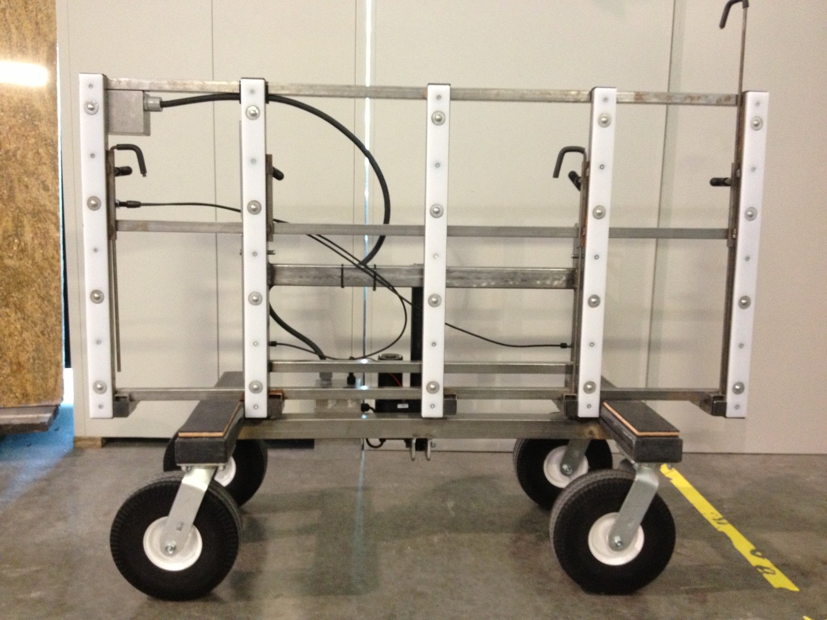 No Lift System prototype #3, unpainted, showing the lifting actuator, cart rotation release pin mechanism, glide strips and transfer balls