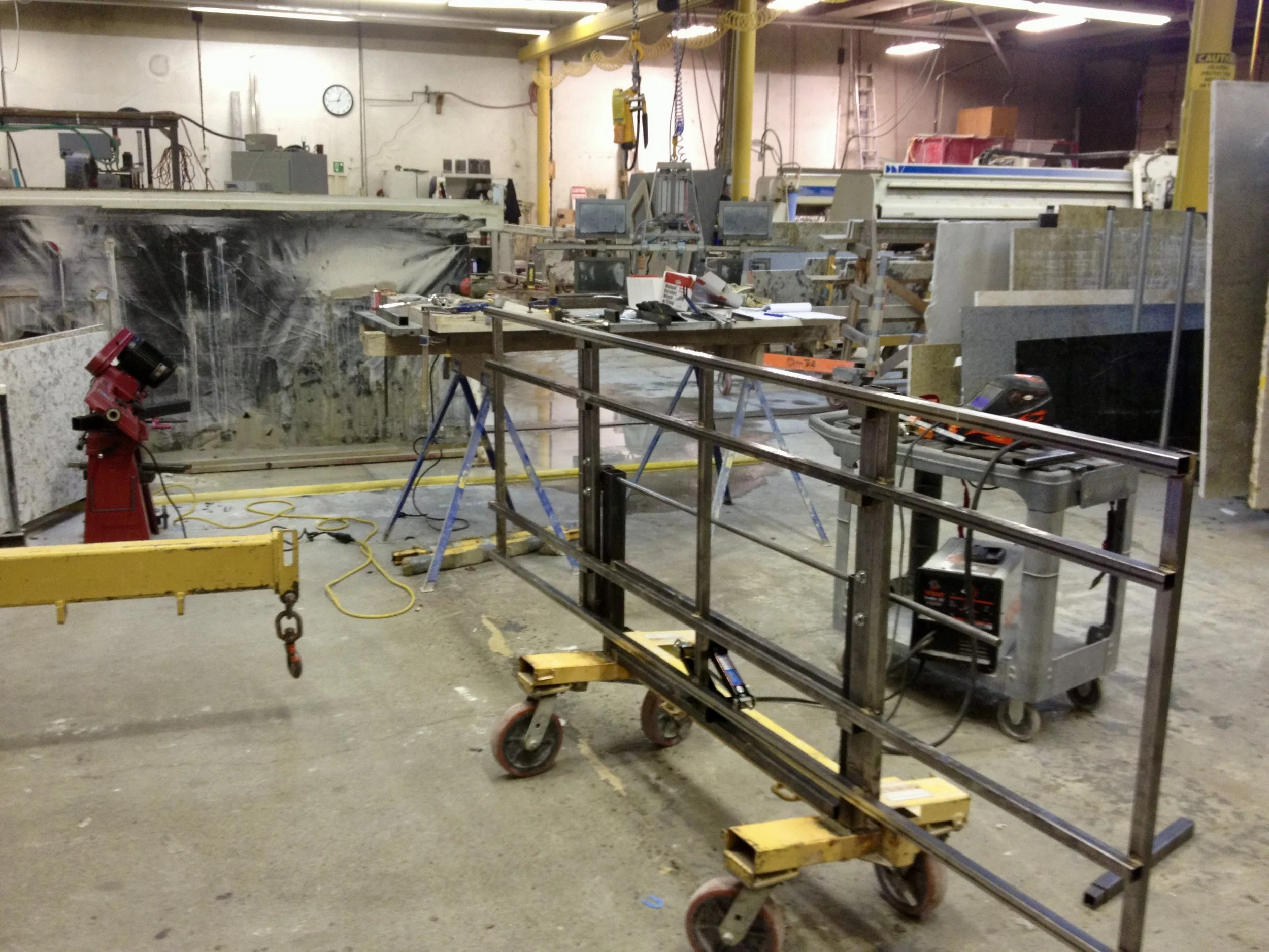 The first No Lift System cart support deck, a welded steel frame mounted on the cart base in a fabrication shop